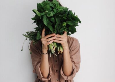 person holding green vegetables